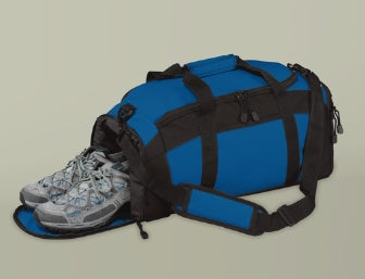 Blue duffel bag with black straps and a gray sneaker on a beige background